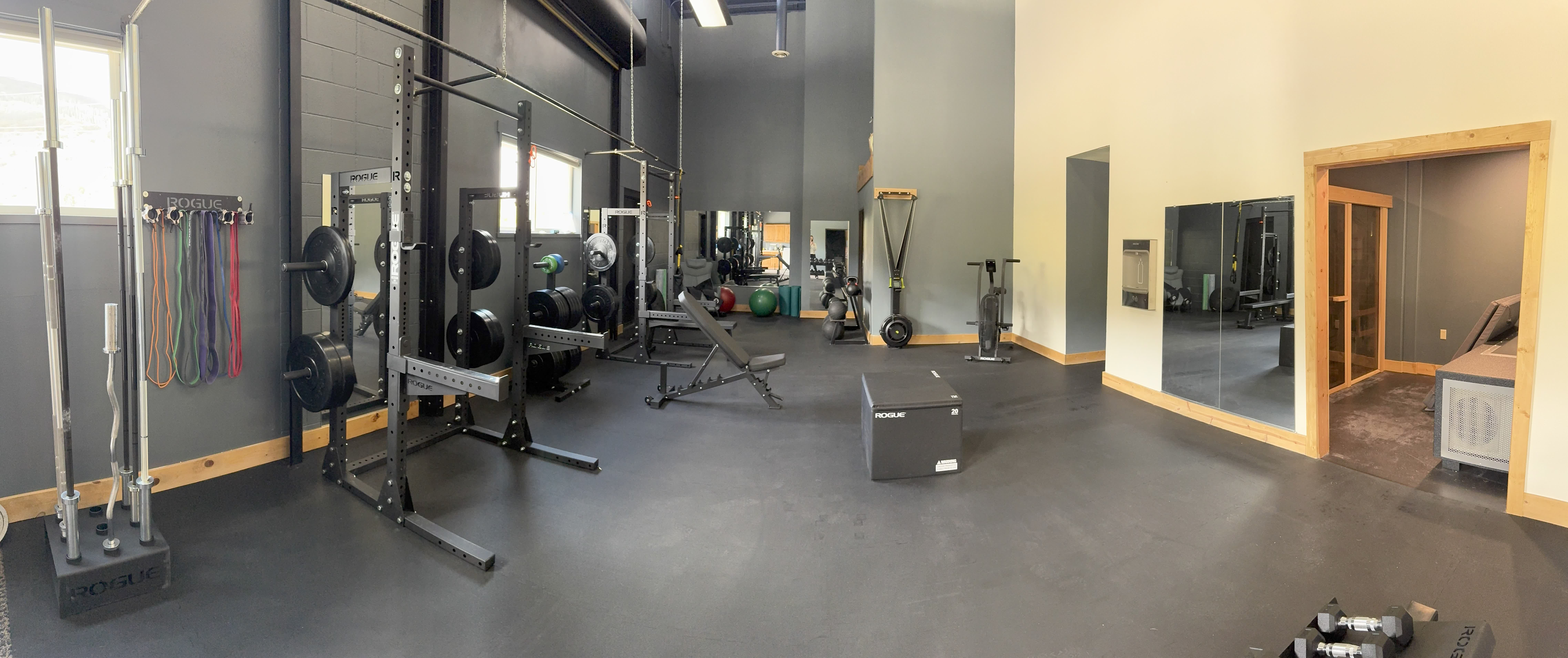 The Gym training floor with squat racks, free weights, and mirrors