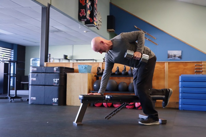 Open gym floor with strength-training equipment