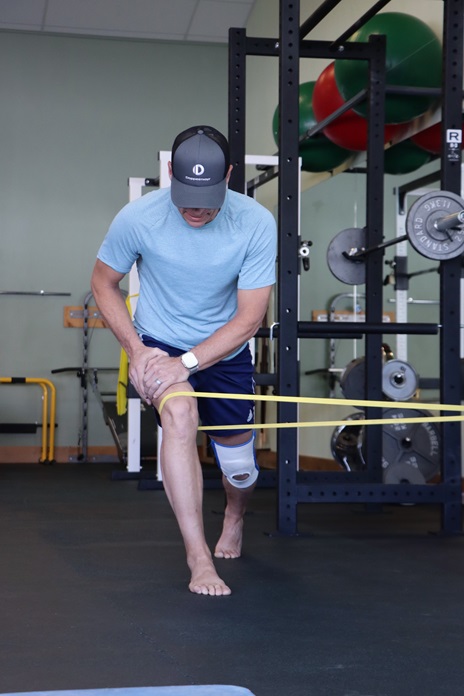 Physical therapist coaching a client on proper form